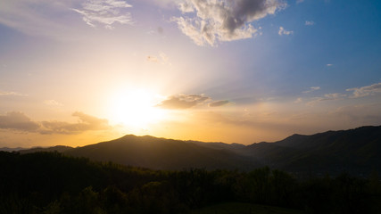 Beautiful landscape in the mountains at sunset. View of colorful sky with amazing clouds.