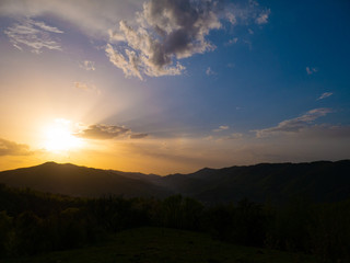 Beautiful landscape in the mountains at sunset. View of colorful sky with amazing clouds.