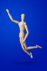 Sports wooden toy figure on blue