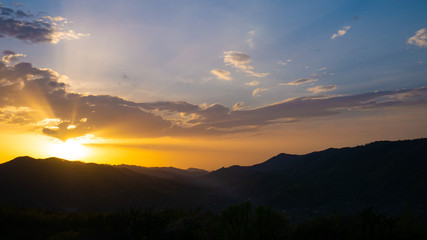 Beautiful landscape in the mountains at sunset. View of colorful sky with amazing clouds.