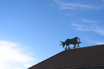 Barn with a silhouette of a cow on the roof