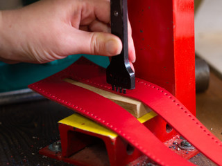 Leather workshop Hands of the girl Red leather
