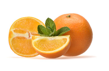 Appetizing composition of sliced juicy oranges and sprigs of green peppermint on a neutral white background