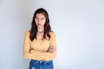 Portrait of offended woman with arms crossed looking at camera isolated on white background