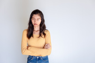 Obraz premium Portrait of offended woman with arms crossed looking at camera isolated on white background