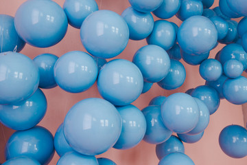 Blue balls on a pink background. Wedding or birthday decoration. Bright background