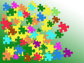 Puzzles of different colors on the green surface