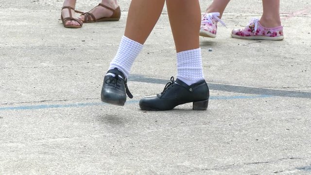 The girl shows the location of the legs during the movement of the Irish dance