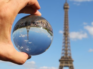 Crystal Sphere on the hand and the Eiffel Tower