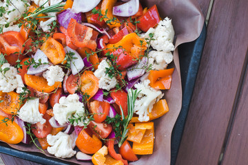 Delicious healthy food. Background of sliced raw vegetables before baking on parchment. The concept of cooking, vegetarianism and healthy eating, healthy vegetarian natural meal.