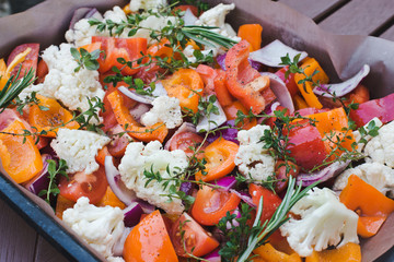 Delicious healthy food. Background of sliced raw vegetables before baking on parchment. The concept of cooking, vegetarianism and healthy eating, healthy vegetarian natural meal.