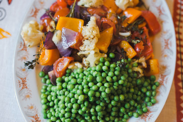 Baked vegetables. Baked vegetables in large pieces on a plate. Vegetarian diet. Close up. Vegetable garnish grill.
