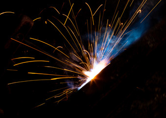 Sparks from welding at a construction site as a background