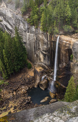 A distance high view of beautiful Vernal Waterfall in Yosemite National Park, just a narrow flume...