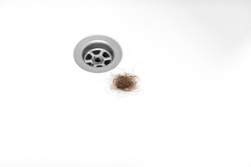 lost hair in the bath. concept on the problem of hair loss
