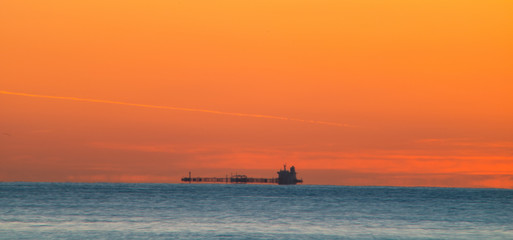 Freighter sailing at dawn