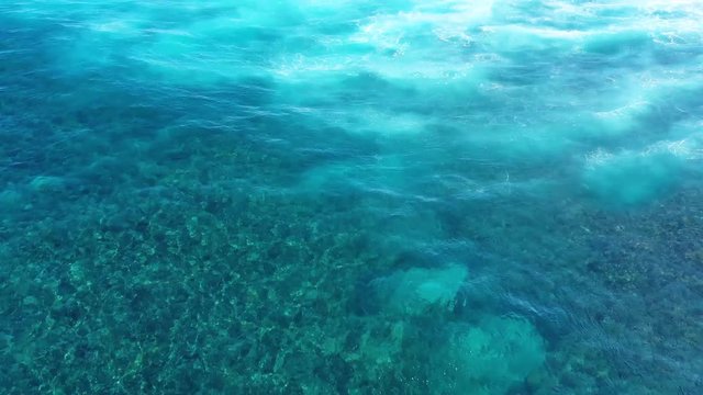 Waves and azure water as a background. View from high rock at the ocean surface. Natural summer seascape. Water background. Indonesia - video
