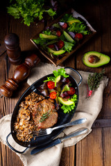 Pork steak with mushrooms and buckwheat groats and mango salad