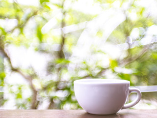 cup of coffee on table in cafe, Morning light blur bokeh nature background