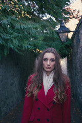 Solemn young woman in a dark alley