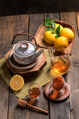 Obraz na płótnie Canvas Hot tea with lemon and natural honey,