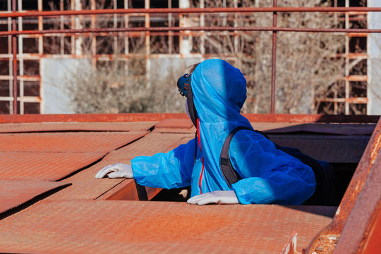 man environmental mask face pack disguise facemask bitmask protective overall blue sky orange rast plant factory disused catastrophe
