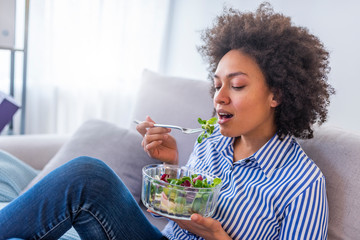 Close-up Of Beautiful African American Woman Eating Salad At Home