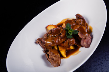 Duck liver with berry sauce and apples decorated with rosemary