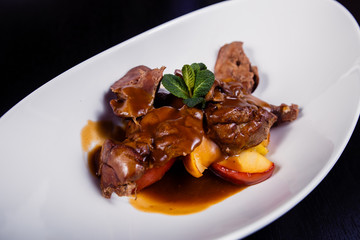 Duck liver with berry sauce and apples decorated with rosemary