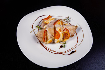 Spicy chicken fillet baked with bacon, tomatoes and cheddar cheese