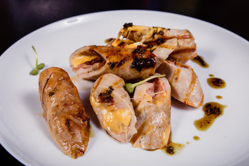 Spicy chicken fillet baked with bacon, tomatoes and cheddar cheese