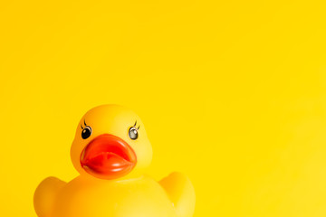 Rubber duck on yellow background minimal creative concept with text space, baby bath