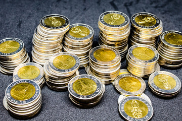 Currency in Thai baht Coin with golden and silver color on black background. Abstract of saving money