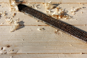 restoration of an old wooden table from pine planks in the workshop, carpentry tools, chisel.