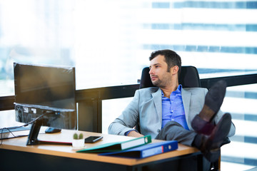 Businessman relaxing in his desk at office