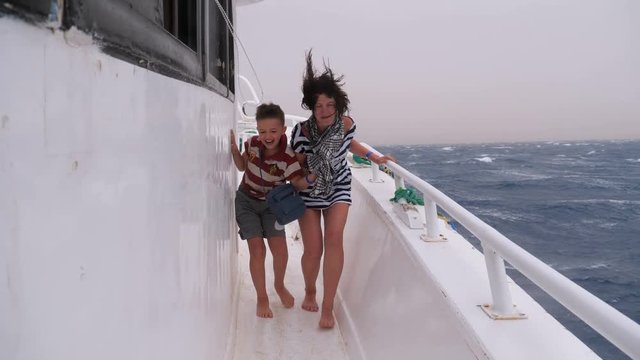 Extreme Shot of Mom and Son on the Ship in a Storm