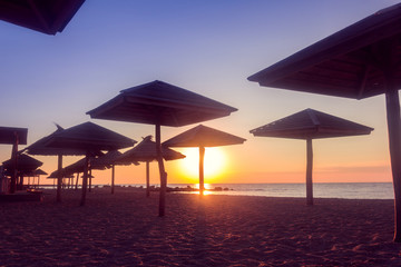 silhouette of straw umbrellas on the sea coast