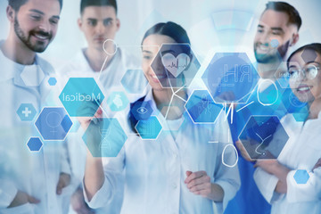 Medical students working with virtual screen in laboratory