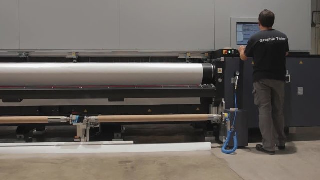 Color management routine. Computer aided printing process, advanced technology in the press and publishing sector, latest generation robotized plotting machines for mass production and big formats.