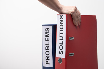 Problems and Solutions - two binders with text on desk in the office