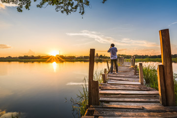 photographer on wooden bridge