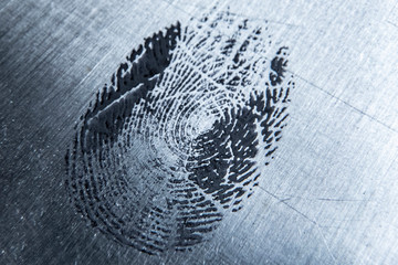 macro photo of a finger print on a metal or glass surface, curves of human skin b