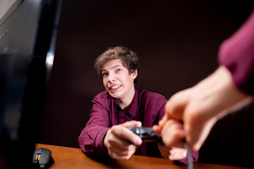 careful parents of a video game addicted young man take away his joystick b
