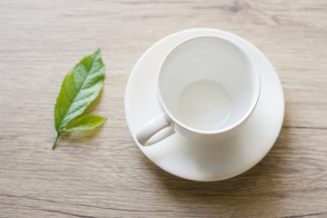 Close up woman hand cleaning coffee cup on the morning with microfiber cloth,Close up woman hand cleaning coffee cup on the rustic wood table.