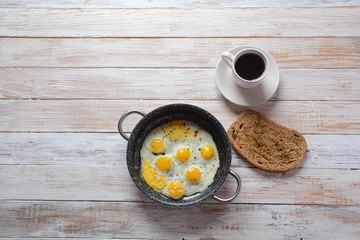 Fried quail eggs in a pan for breakfast. Healthy organic food