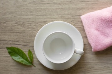 Close up woman hand cleaning coffee cup on the morning with microfiber cloth,Close up woman hand cleaning coffee cup on the rustic wood table.