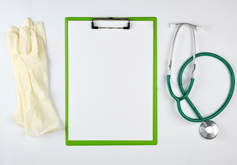 black medical stethoscope and green paper holder