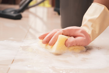 woman on cleaning the floor close up