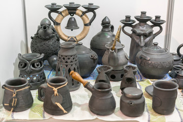 Clay dishes. Ceramic national Ukrainian dishes made in the Poltava region in the village of Opishnya and demonstrated at the in Velyki Sorochyntsi Fair. Burnt black ceramics. Burned clay jars