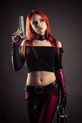 luxurious woman in suit with gun and case in hand